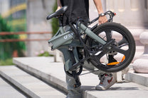 Person carrying the folded DYU T1 folding e-bike