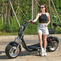 Woman standing with the eHoodax X10 City Road electric scooter