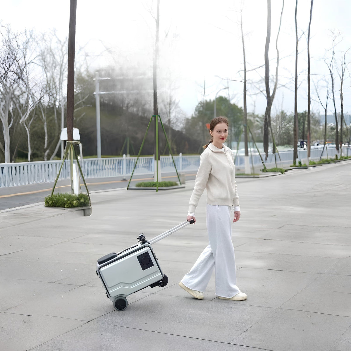 Person pulling the PowerDrive Pro Edition electric ride-on suitcase outdoors