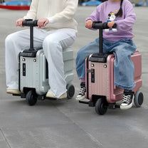 Two people each riding a PowerDrive Pro Edition electric ride-on suitcase
