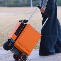 Person pulling the Urban Move Edition electric ride-on suitcase in orange outdoors
