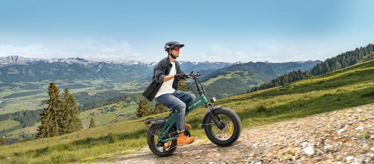 Man riding the ENGWE EP-2 3.0 Boost folding fat-tyre e-bike on a grassy field
