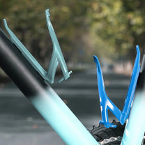 Bottle holder for e-bike frames in blue on a bicycle outdoors