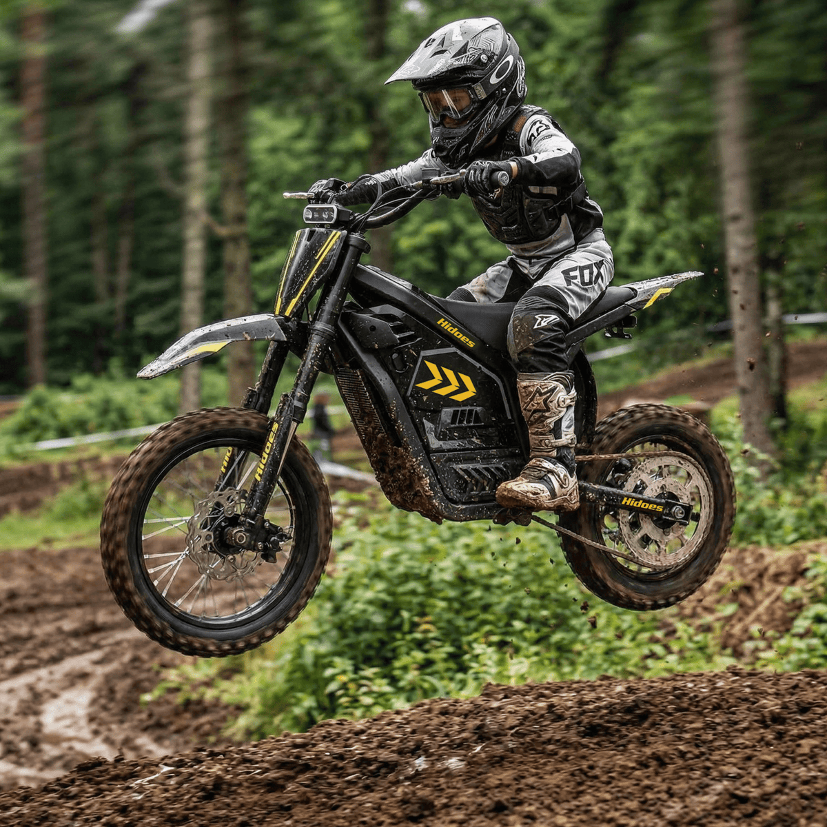 Rider taking the Hidoes G2 electric dirt bike off-road in the forest