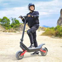 Man riding the HX X10 electric scooter on sandy ground