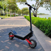 HX X10 electric scooter, front three-quarter view on a footpath