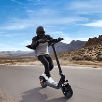 Person riding the HX X9B electric scooter on a road