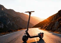 HX X9B electric scooter, front three-quarter view at sunset