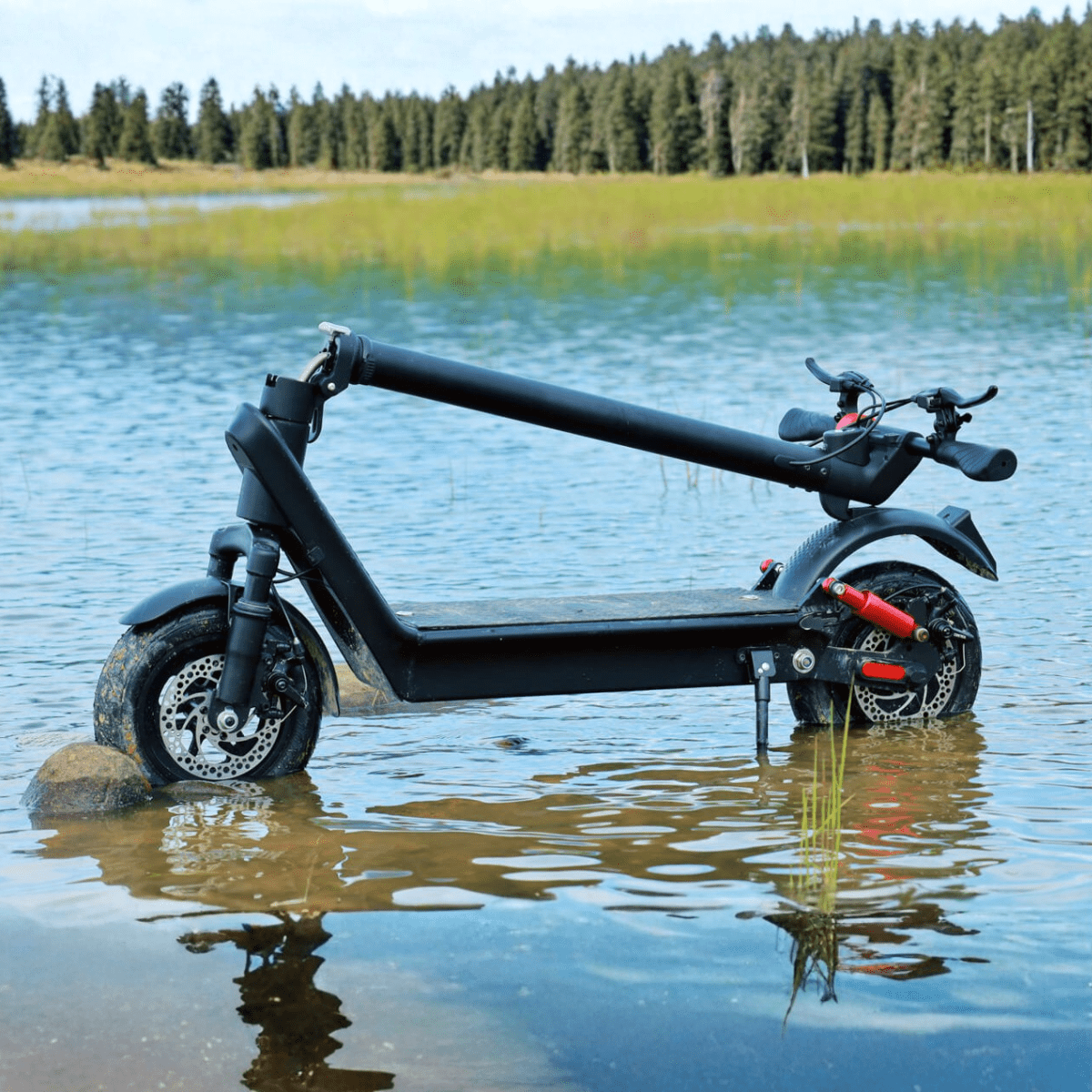HX X9B electric scooter folded by a lake