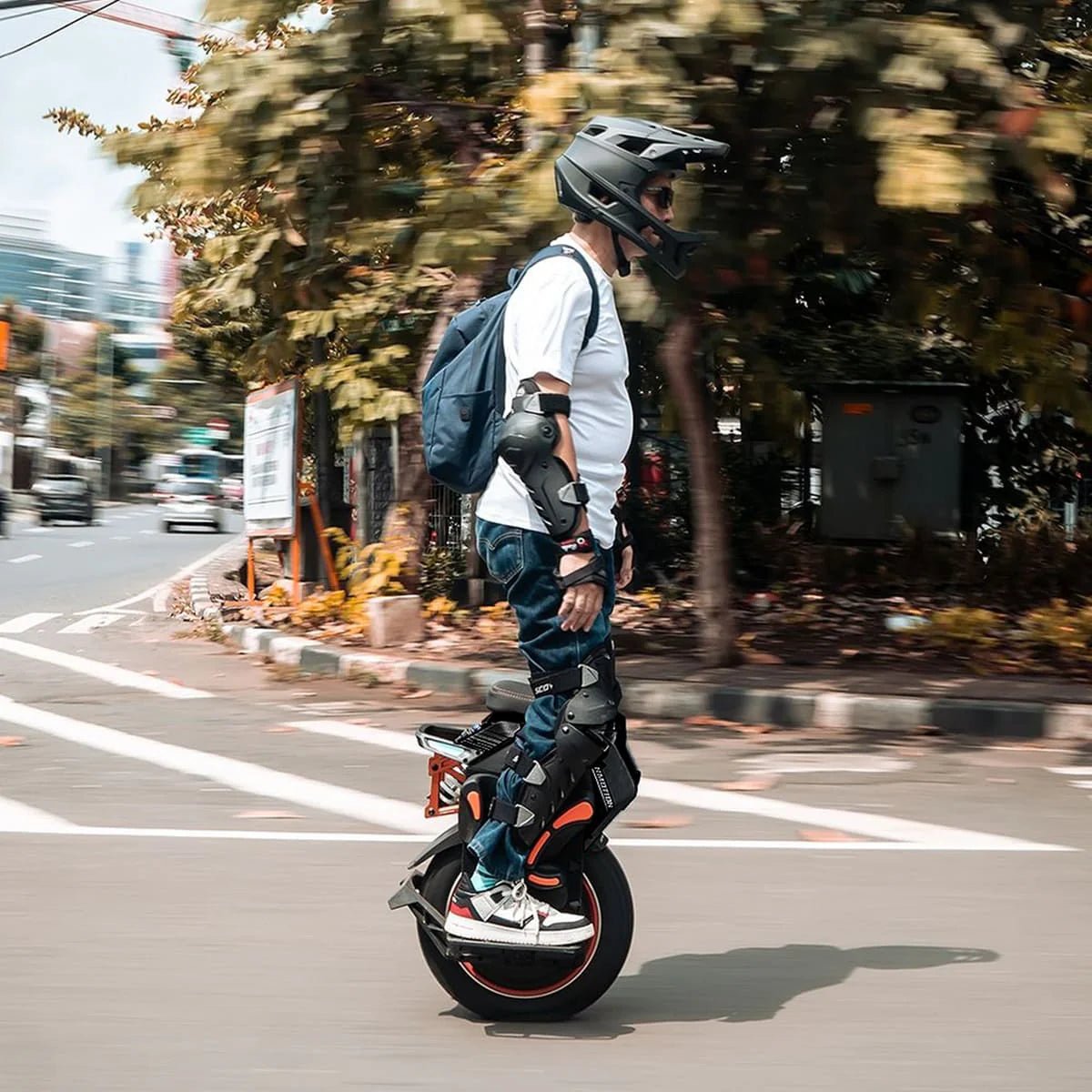 Man riding the InMotion V14 Adventure electric unicycle in the city