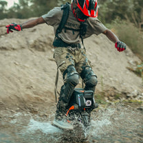 Person riding the InMotion V14 Adventure electric unicycle on a trail