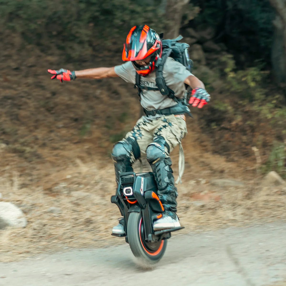 Person riding the InMotion V14 Adventure electric unicycle on a trail