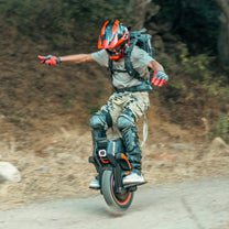Person riding the InMotion V14 Adventure electric unicycle on a trail