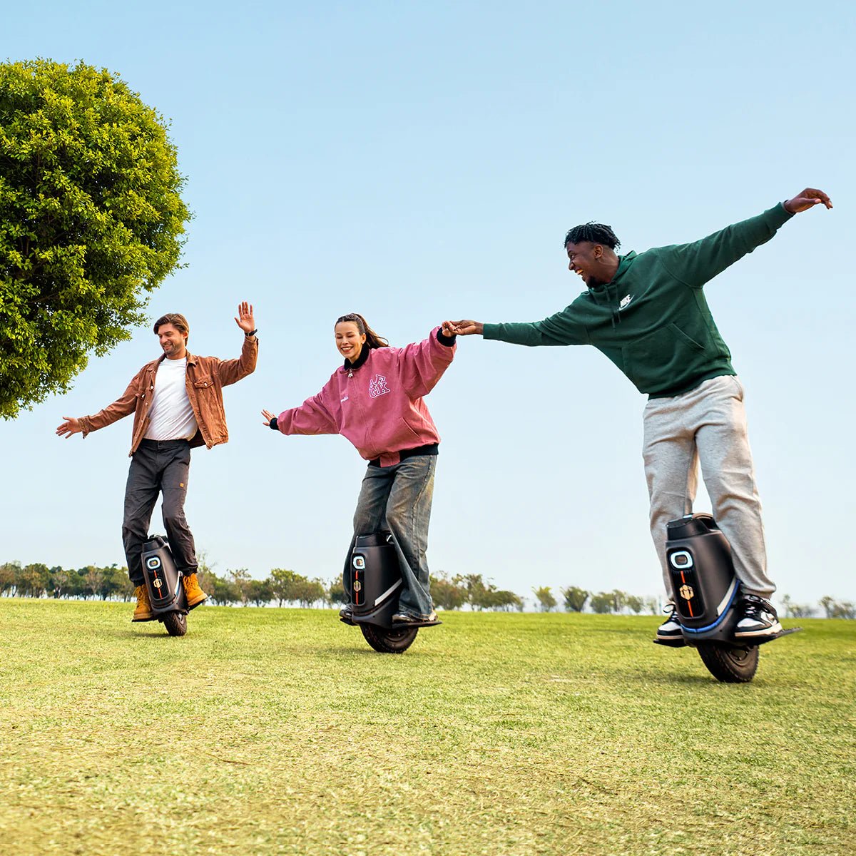 Person riding the InMotion V9 electric unicycle on a grassy field