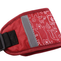 Close-up of adjustable safety harness with reflective material in red