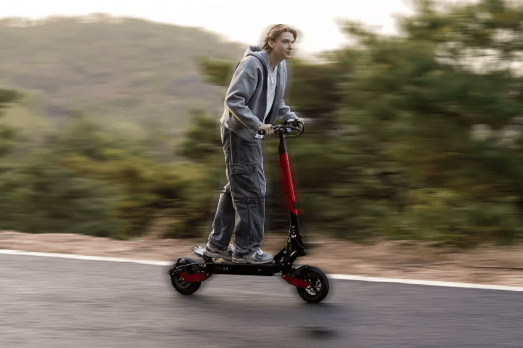 Person riding the KOOLUX U1 electric scooter on a road