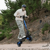 Man riding the KOOLUX U1 Pro electric scooter on a trail