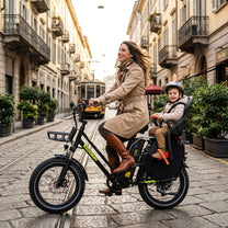 Woman riding the KOOLUX X8 fat-tyre e-bike with a child