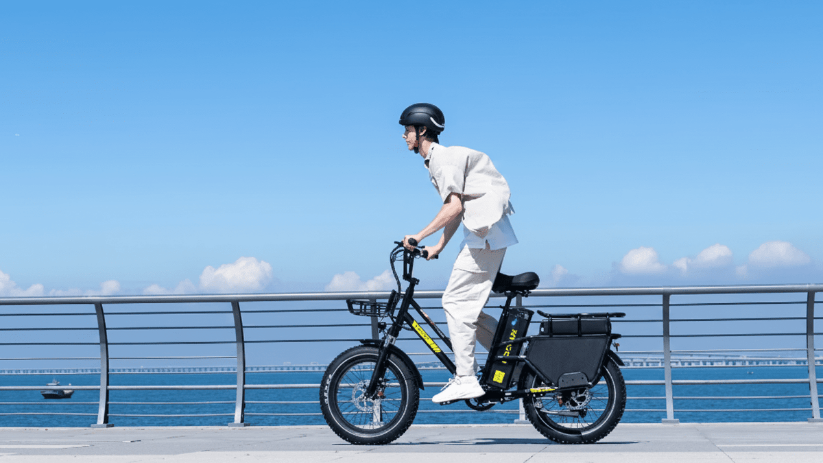 Man riding the KOOLUX X8 fat-tyre e-bike by the sea