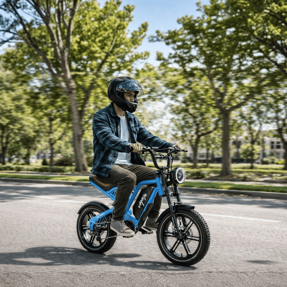 Person riding the KOOLUX X9 Mini fat-tyre e-bike in a park