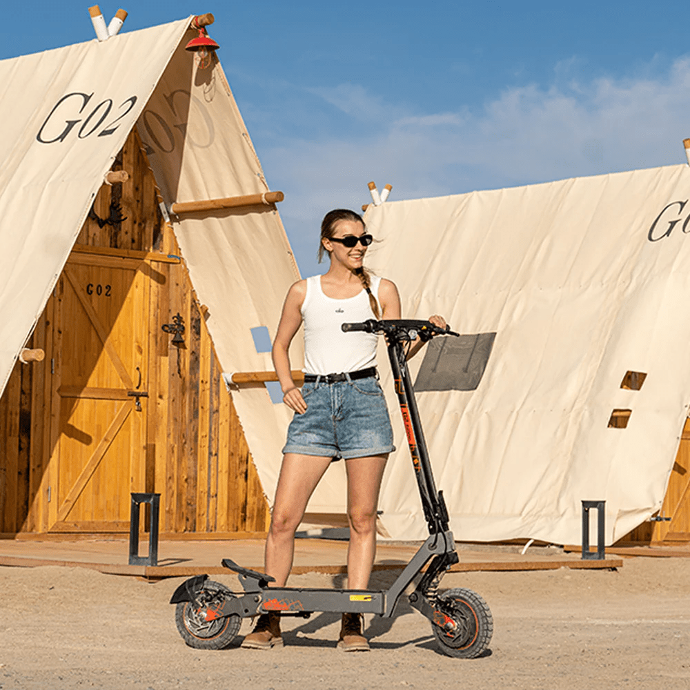 Woman standing with the KuKirin G2 Ultra electric scooter