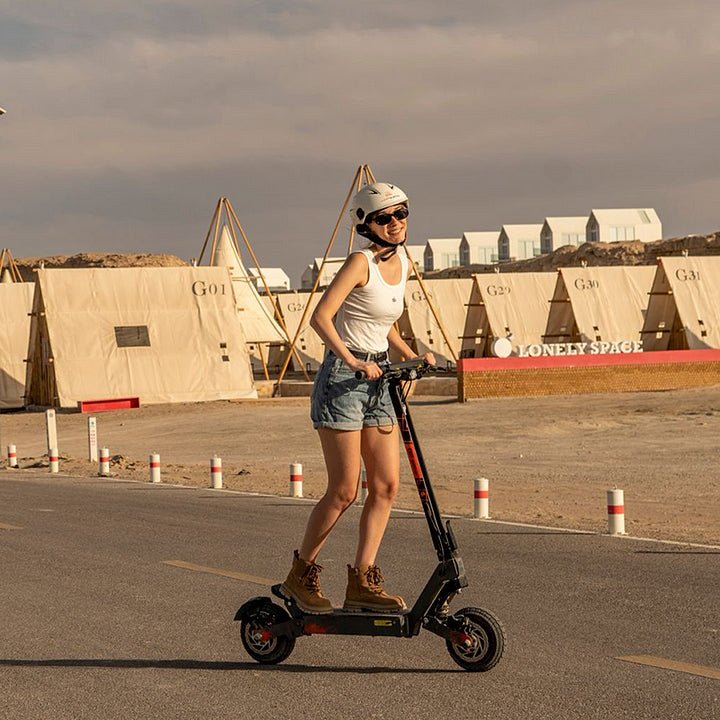Woman riding the KuKirin G2 Ultra electric scooter in the city