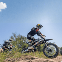 Rider taking the KuKirin X1 electric dirt bike off-road