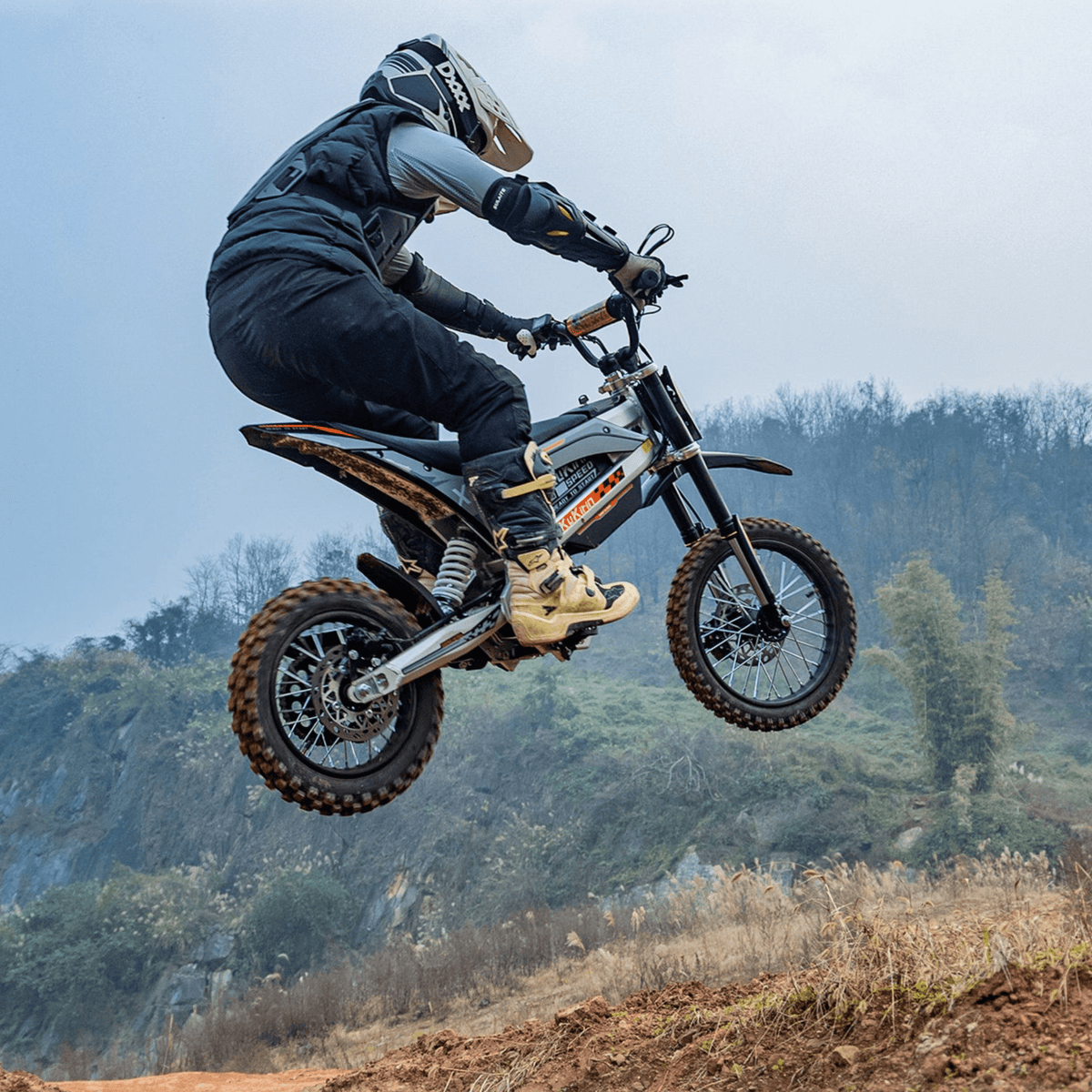 Rider jumping with the KuKirin X1 electric dirt bike