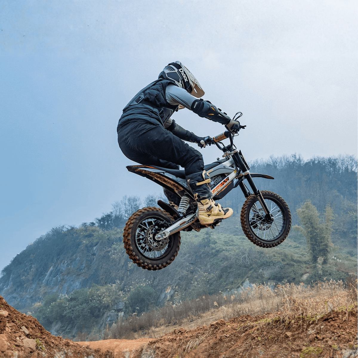 Rider jumping with the KuKirin X1 electric dirt bike