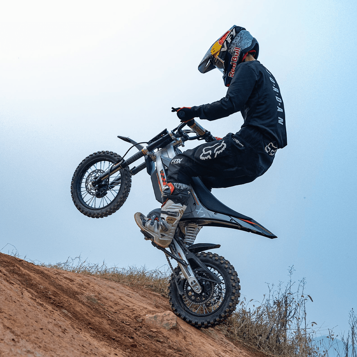 Rider jumping with the KuKirin X1 electric dirt bike