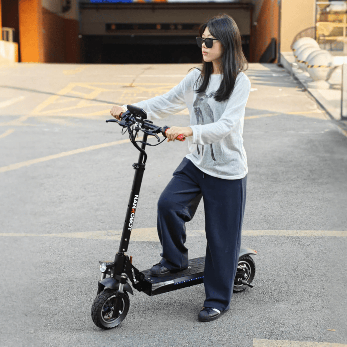 Woman standing with the Nanrobot T1 electric scooter
