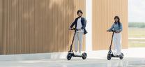 Person riding the NAVEE V25i Pro II electric scooter in the city