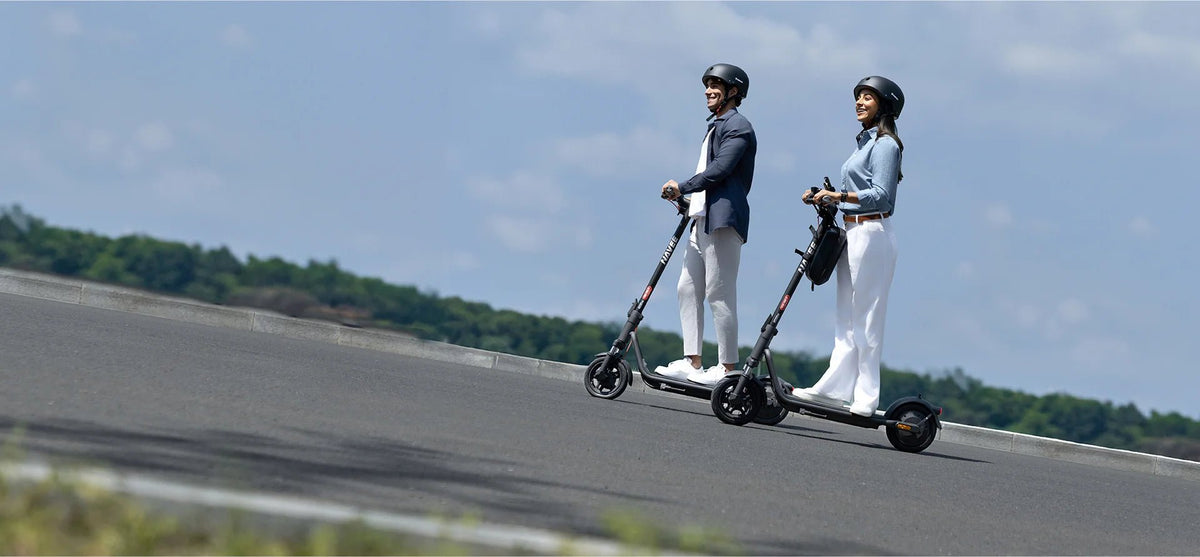 Person riding the NAVEE V25i Pro II electric scooter in the city in a group