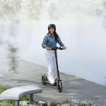 Woman standing with the NAVEE V25i Pro II electric scooter