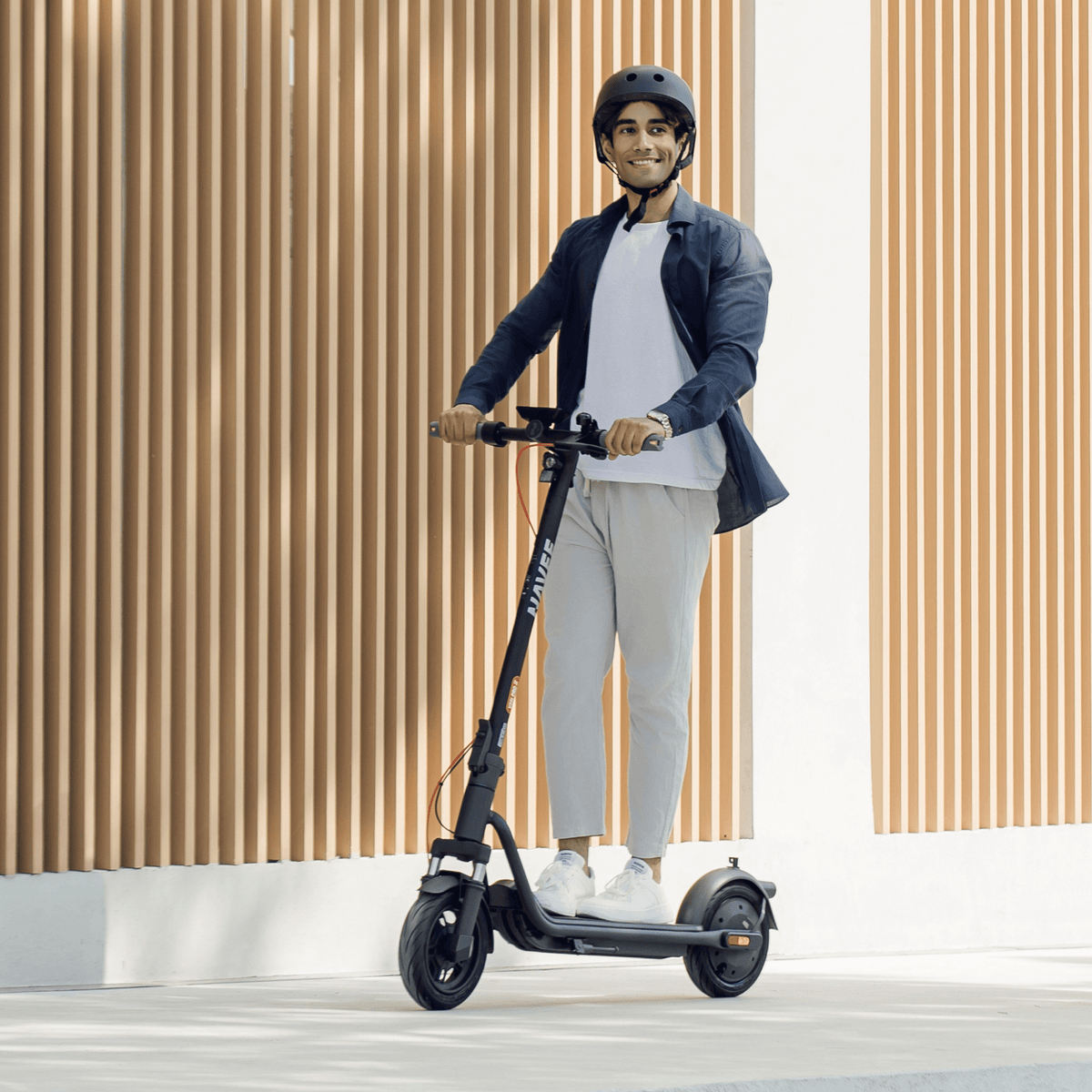 Person standing with the NAVEE V25i Pro II electric scooter