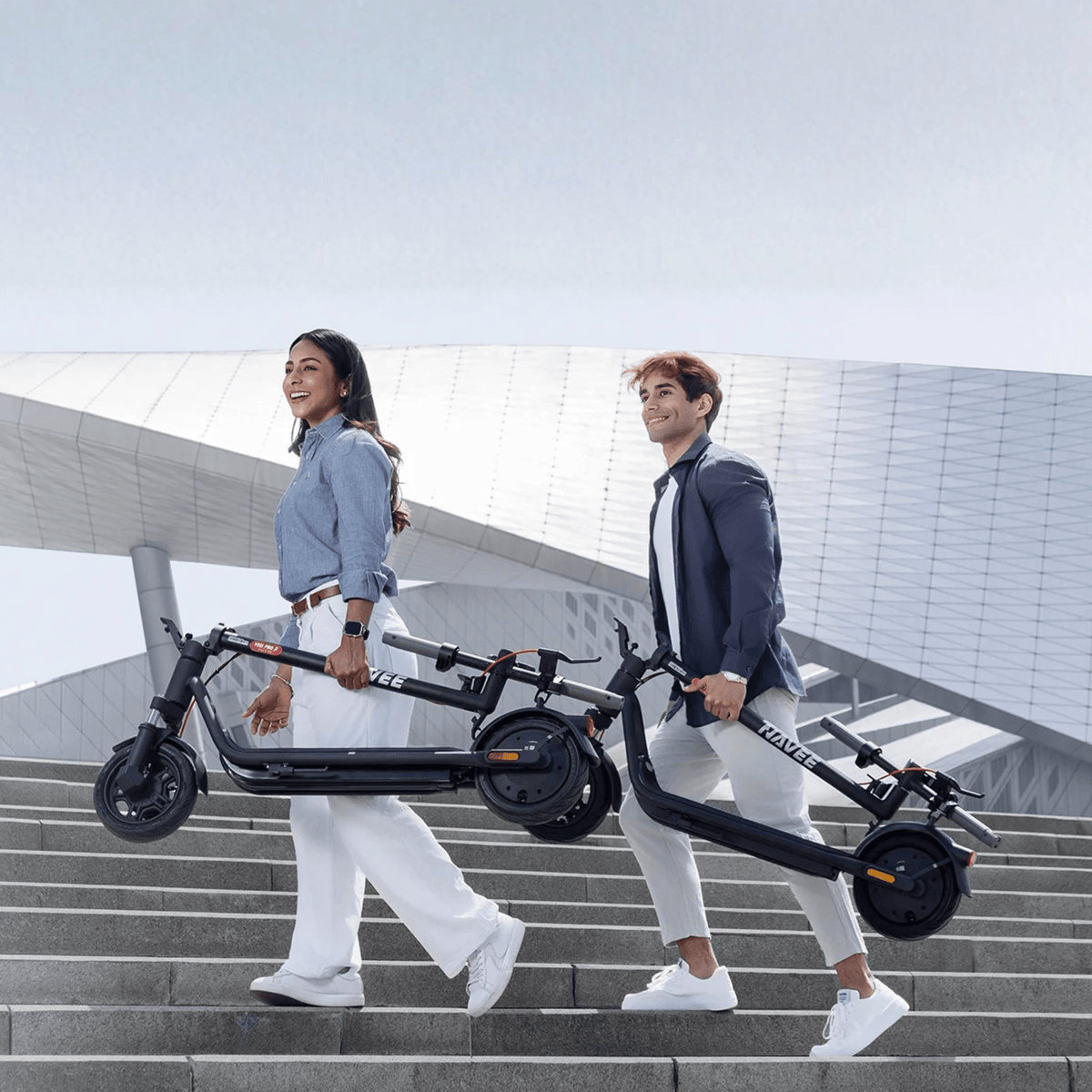 Person carrying the folded NAVEE V25i Pro II electric scooter