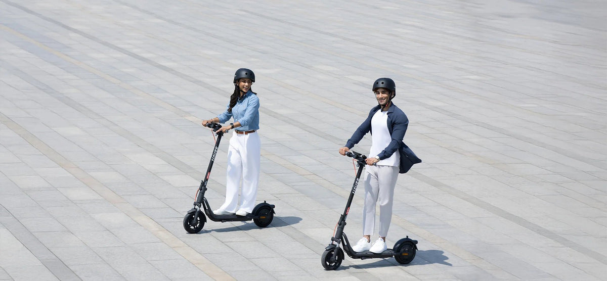 Person riding the NAVEE V25i Pro II electric scooter in the city in a group