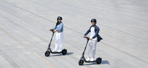 Person riding the NAVEE V25i Pro II electric scooter in the city in a group