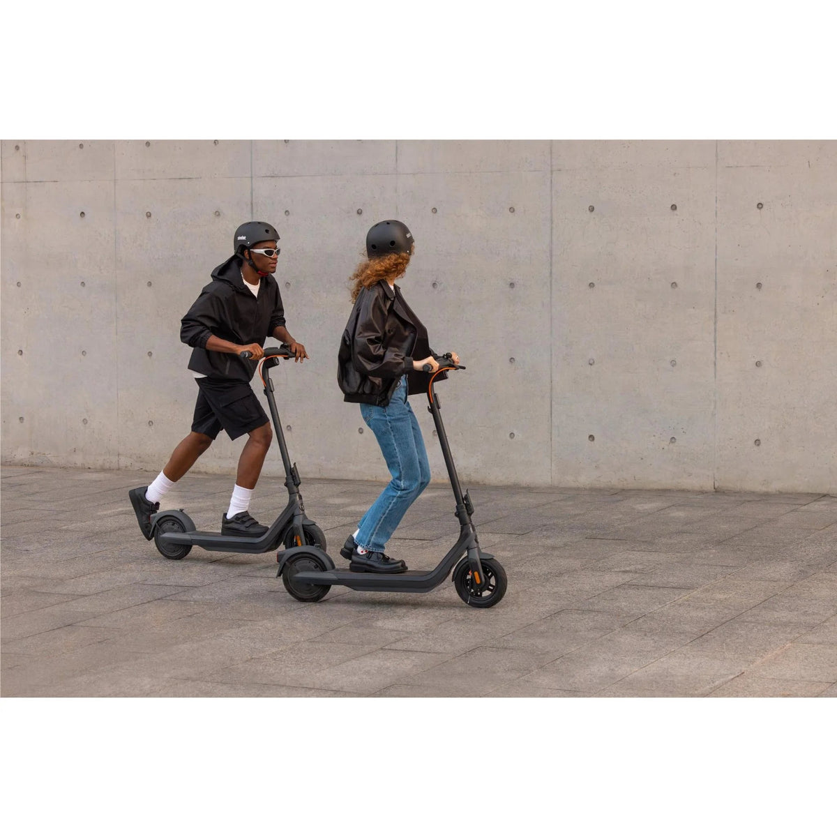 Person riding the Segway Ninebot E2 Pro electric scooter in the city