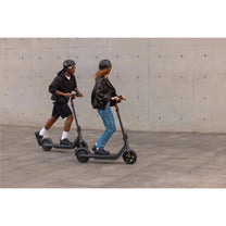 Person riding the Segway Ninebot E2 Pro electric scooter in the city