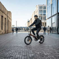 Man riding the Onemile E2 folding e-bike on a street