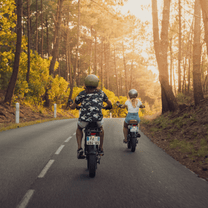 Two riders with the Onemile P40 Pro fat-tyre e-bike on a road