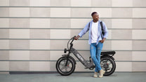 Man standing with the OneSport OT08 Pro fat-tyre e-bike in grey on a street