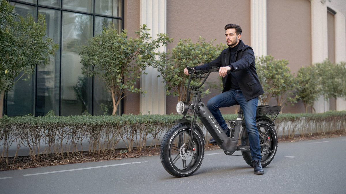Man riding the OneSport OT08 Pro fat-tyre e-bike in grey on a street