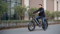 Man riding the OneSport OT08 Pro fat-tyre e-bike in grey on a street