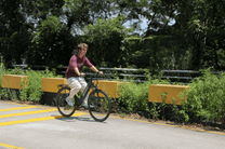 Person riding the OneSport OT12 e-bike in black in a park