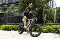 Man riding the OneSport W66 fat-tyre e-bike in a park