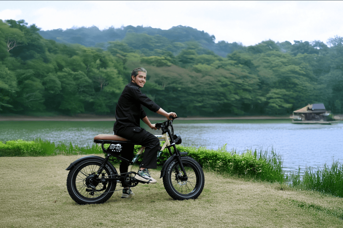 Man riding the OneSport W66 fat-tyre e-bike by a lake
