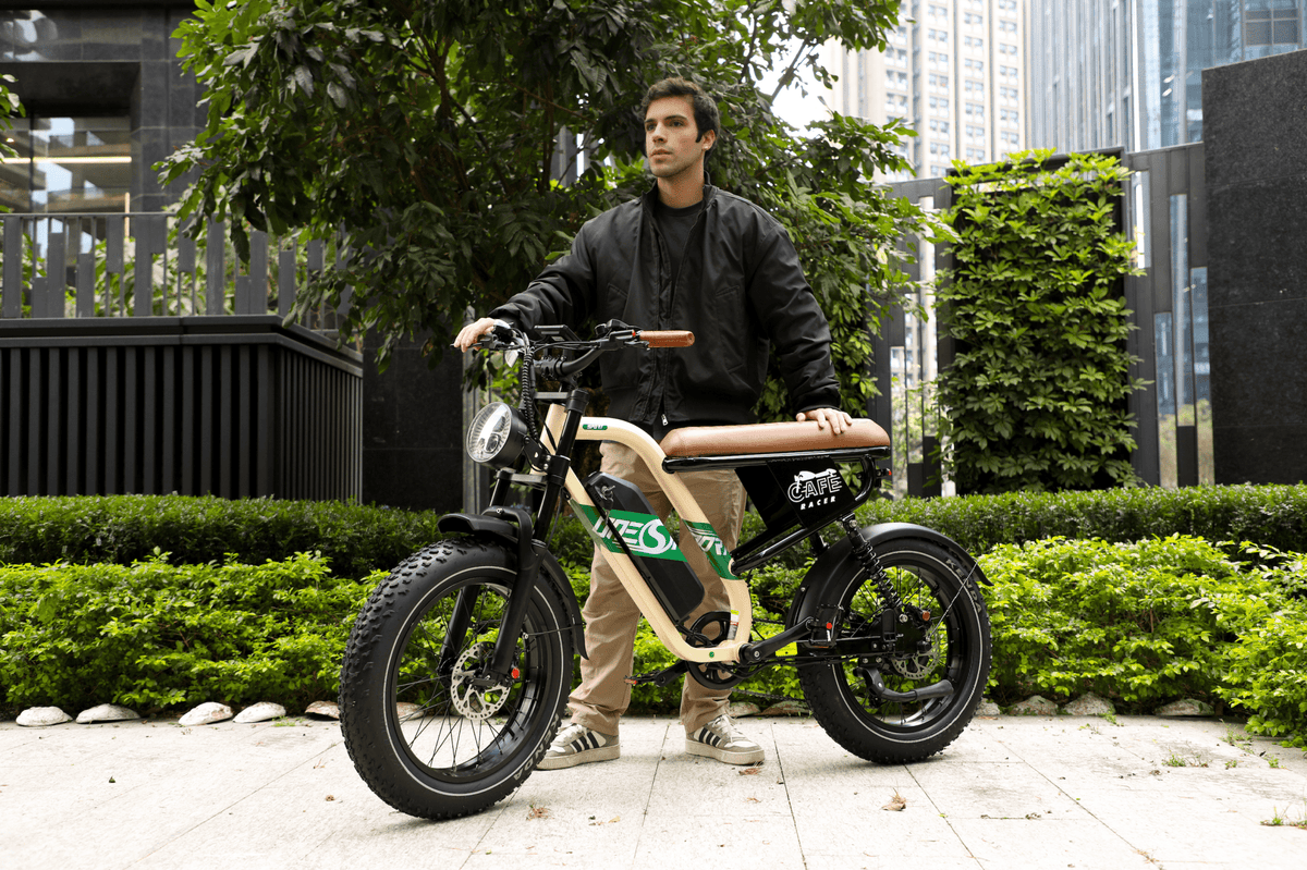 Man sitting on the OneSport W66 fat-tyre e-bike in a park