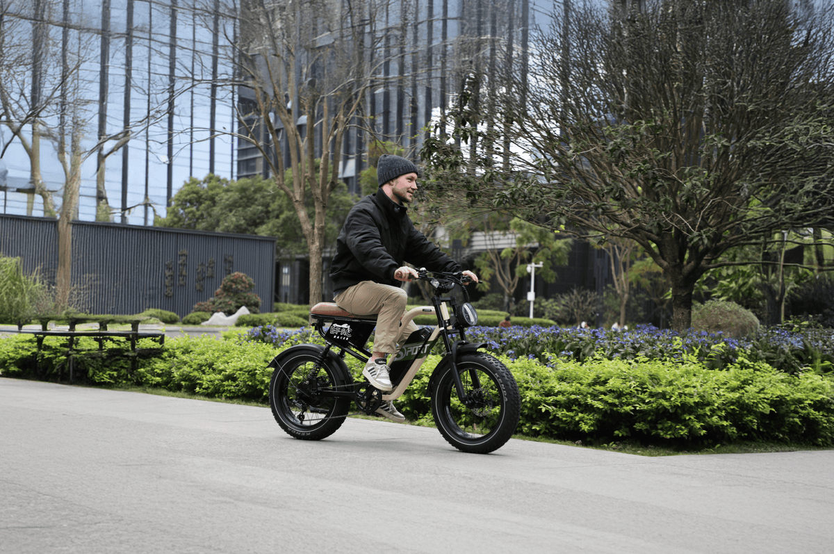 Man riding the OneSport W66 fat-tyre e-bike on a footpath